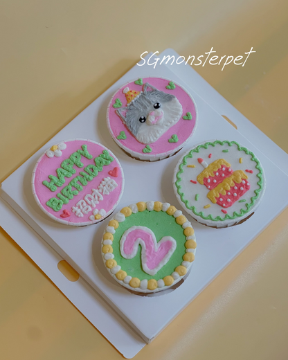 Four small round cupcakes with decorative icing on a white square plate.