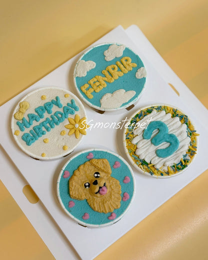 Four round cupcakes with decorative icing on a white card, featuring text and a dog illustration.