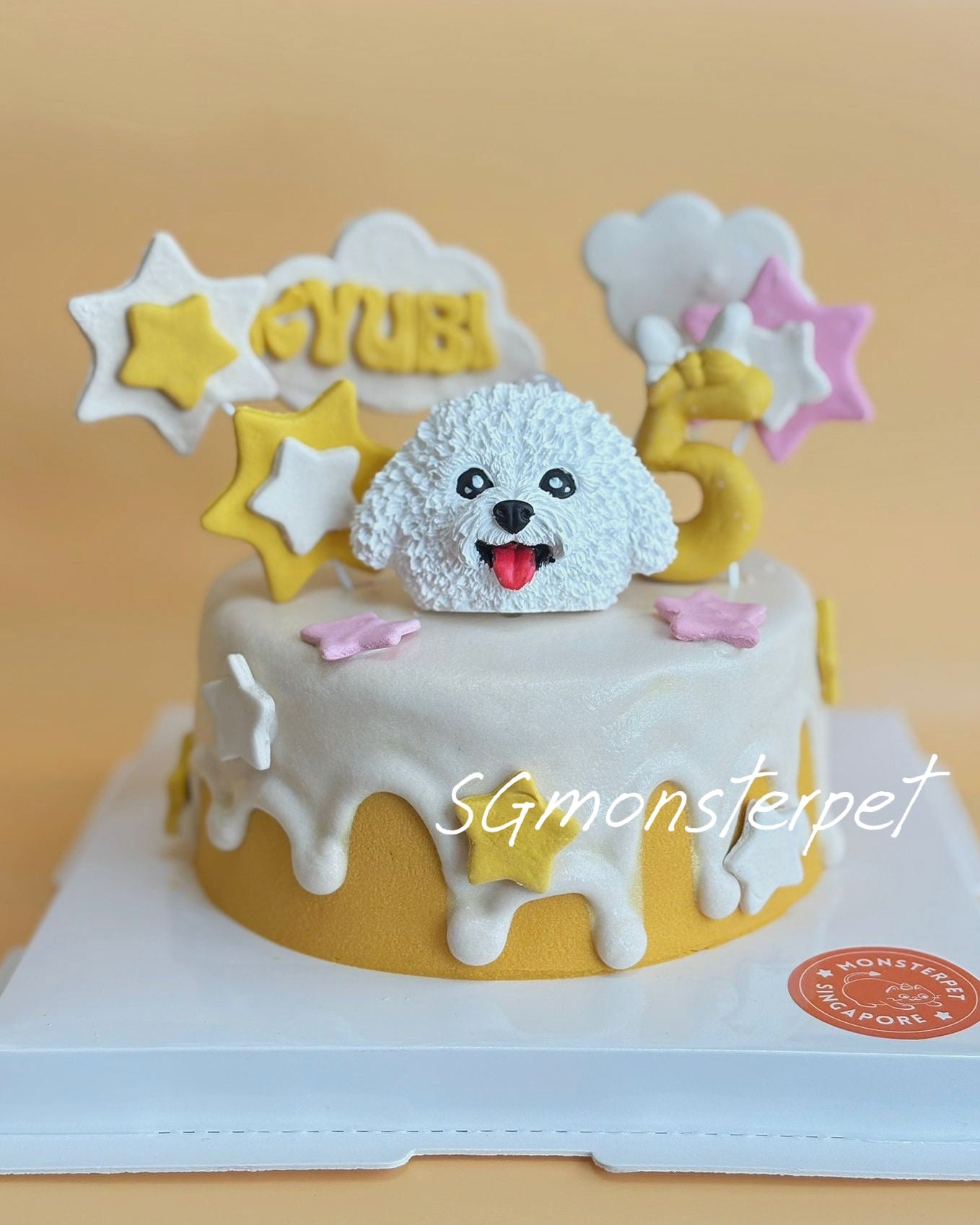 Pet cake with a dog topper and star decorations