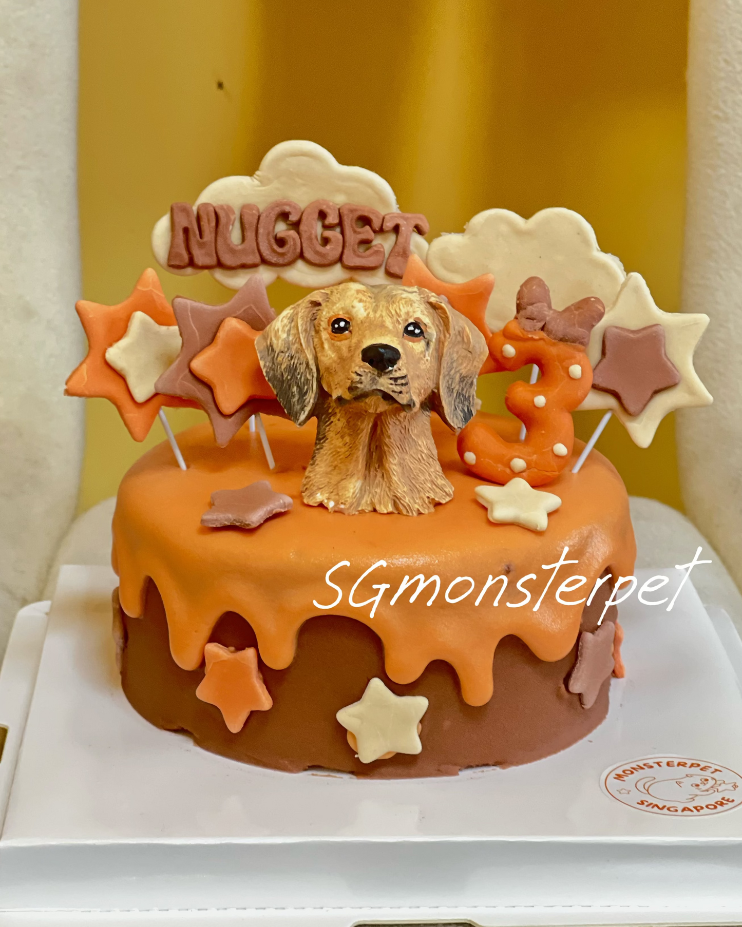 Dog-themed birthday pet cake with a dog figurine and decorative stars
