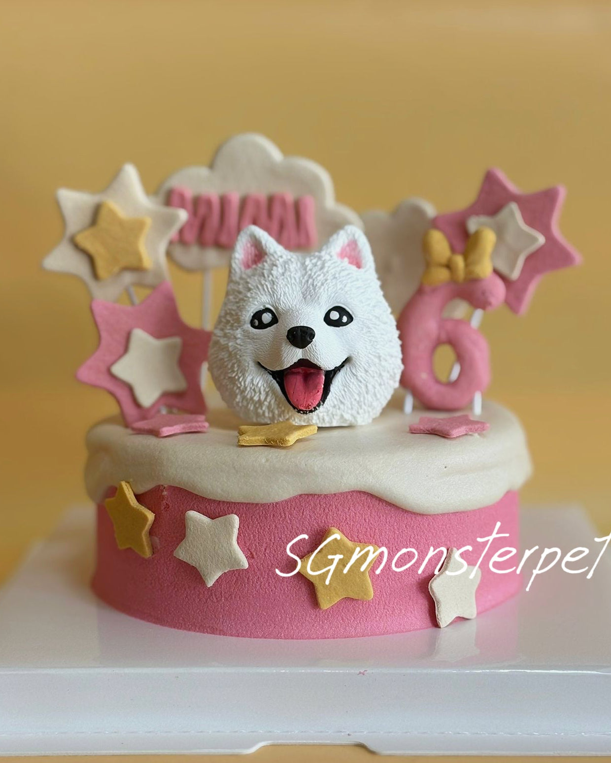 Pet birthday cake with a dog figurine and stars decorations