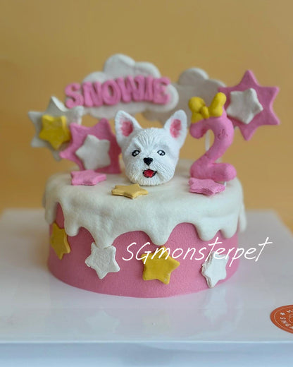 Pet birthday cake with a dog figurine and stars decorations