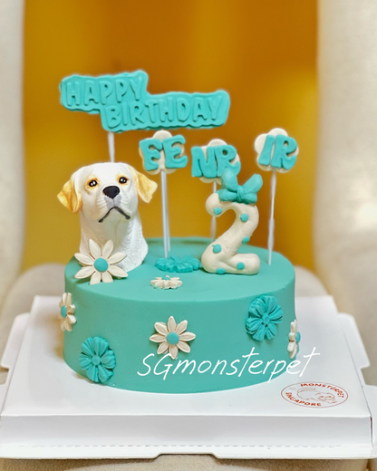 Teal birthday pet cake with dog figurine and 'Happy Birthday' topper on a white surface.