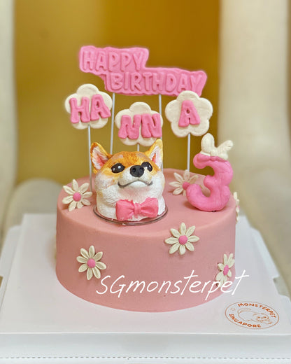Pink birthday pet cake with a dog figurine and 'Happy Birthday' topper on a white chair.