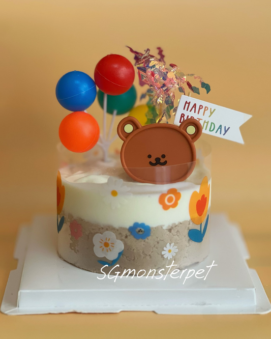 Small birthday cpet ake with teddy bear topper and colorful balloons