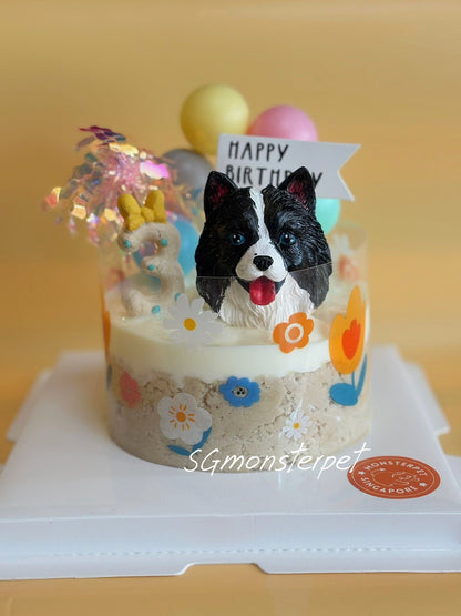 Dog-themed birthday pet cake with a figurine and 'Happy Birthday' sign.