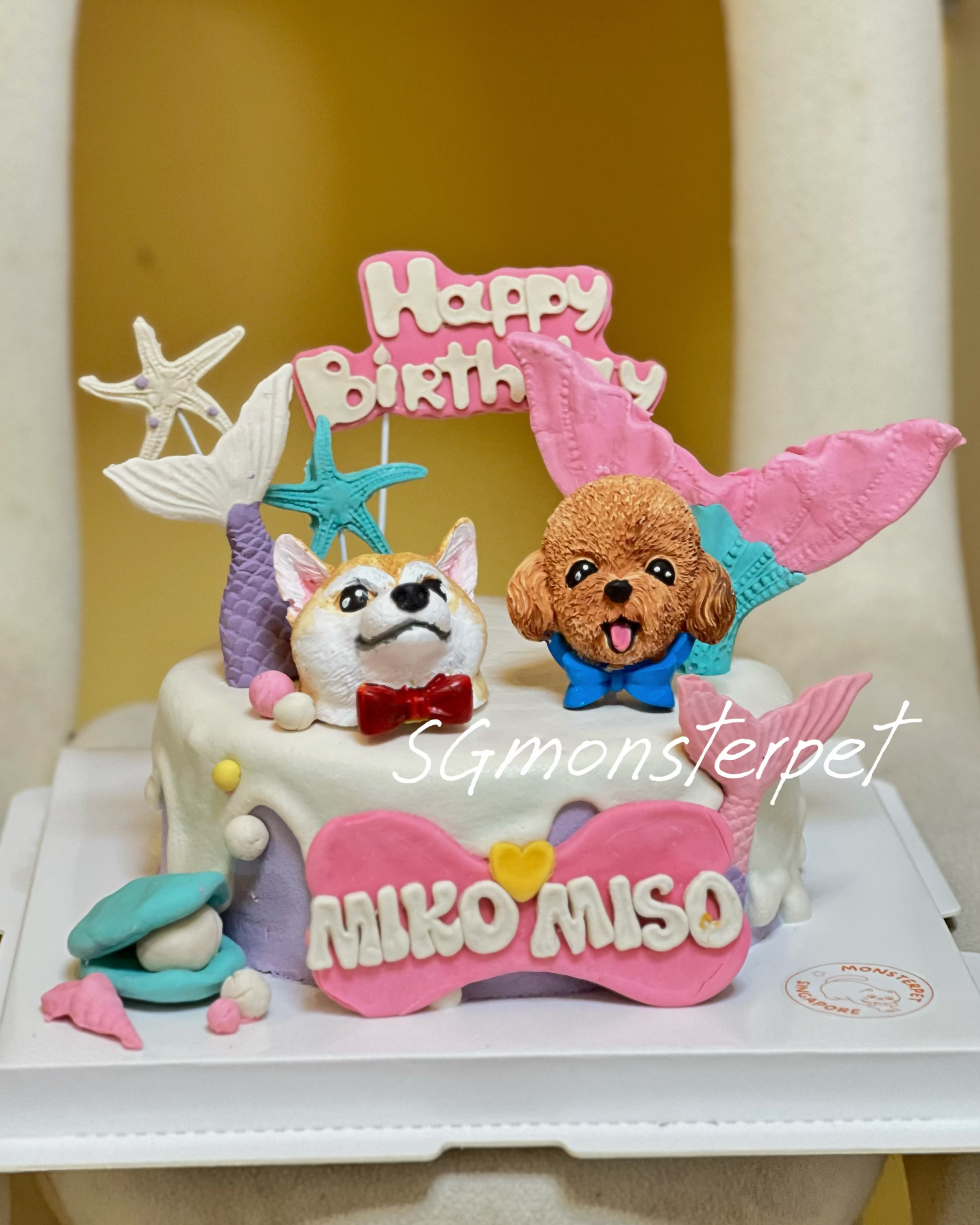 Birthday pet cake with dog-themed decorations and 'Happy Birthday' topper