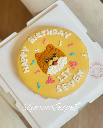 Dog-shaped birthday pet cake with 'Happy Birthday' and age text on a yellow background, in a white box.