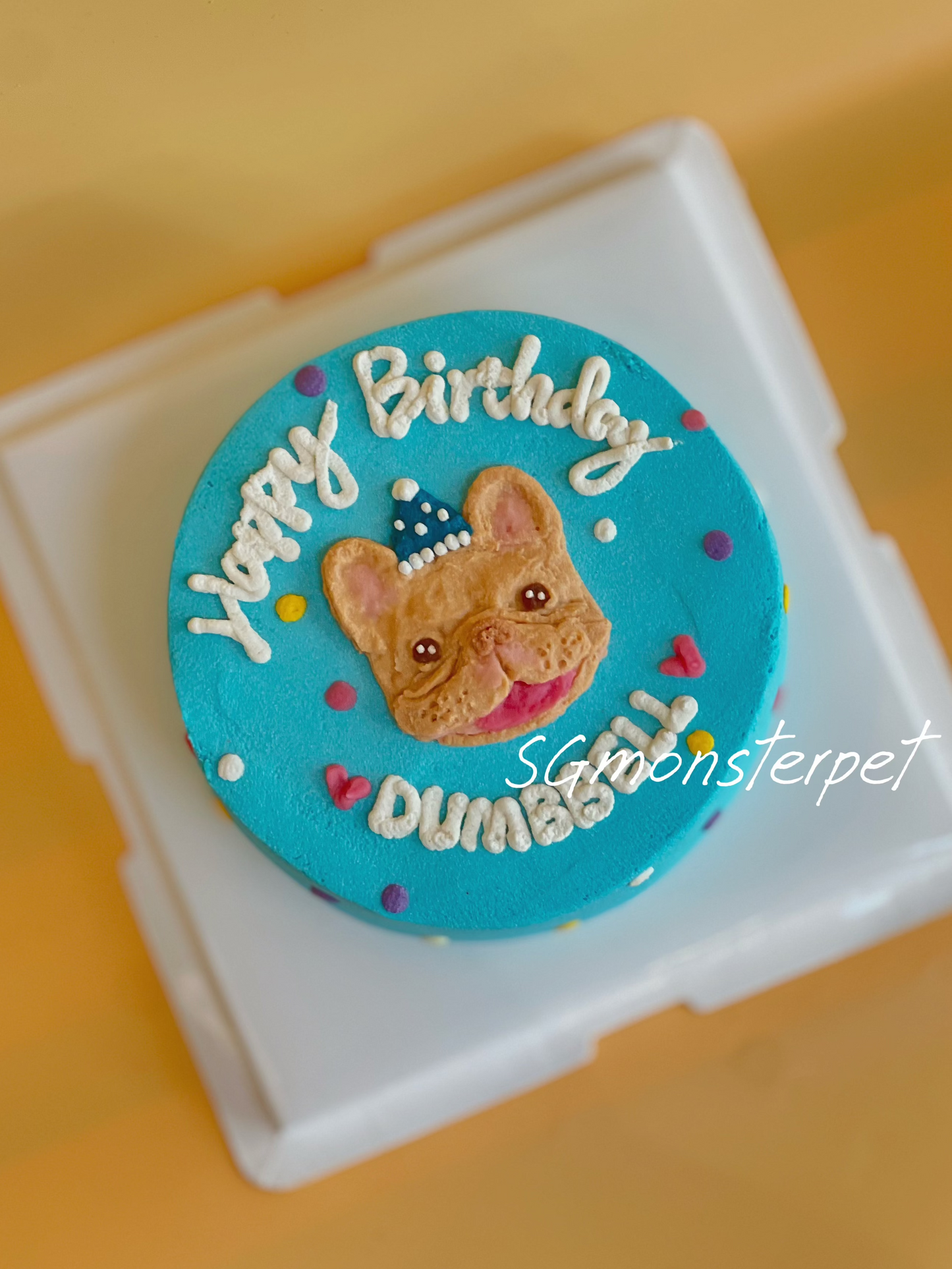 Round blue birthday pet cake topper with a dog's face and 'Happy Birthday' text.