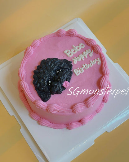 Small pink birthday pet cake with a black dog decoration.
