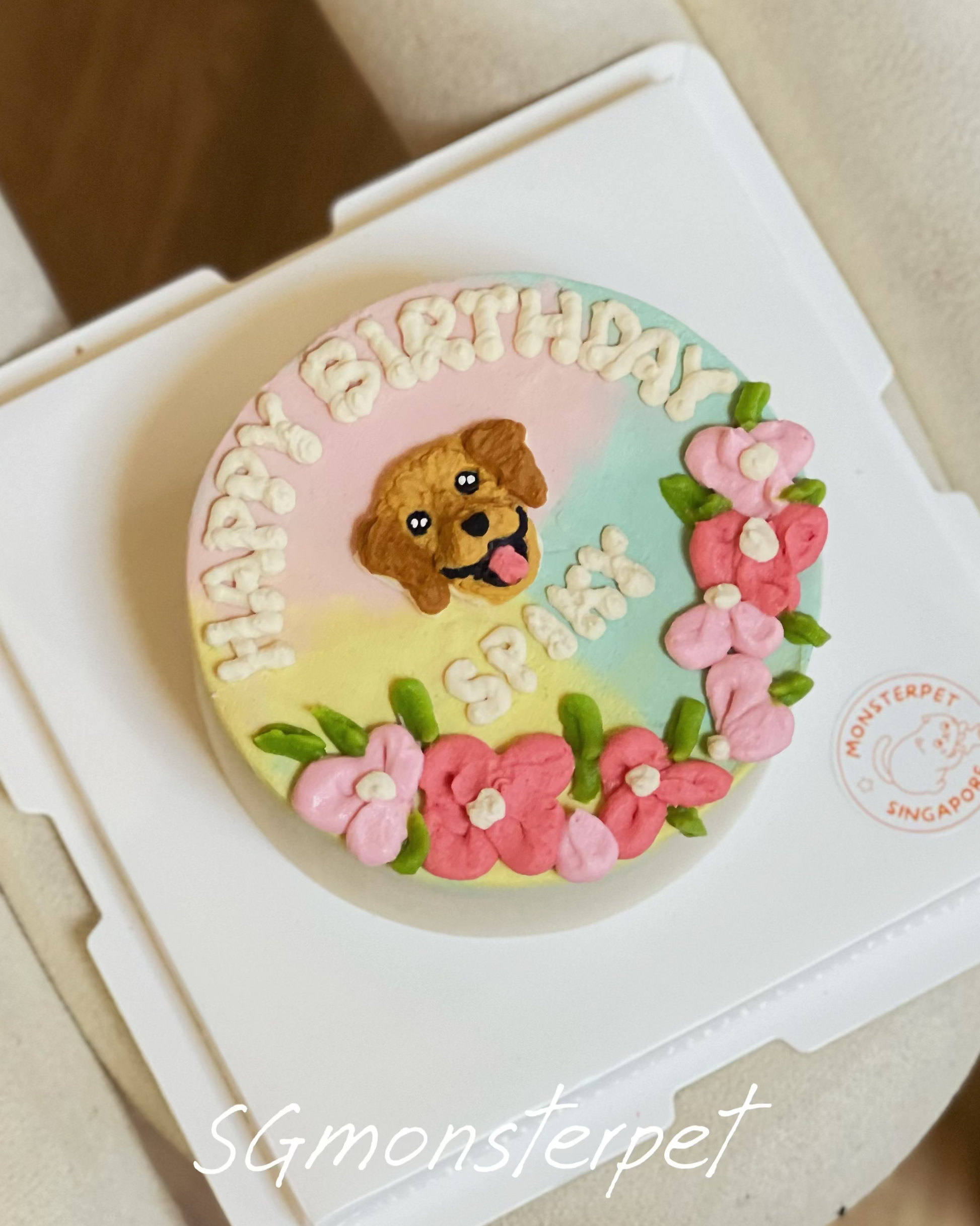 birthday pet cake with a dog design and 'Happy Birthday' text, placed on a white stand.