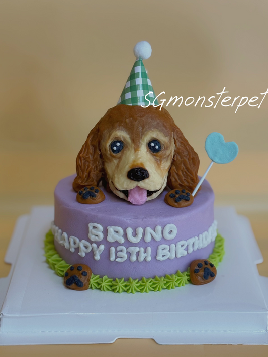 Dog-shaped birthday cake with a purple base and 'Happy Birthday' text, featuring a dog figurine wearing a party hat.