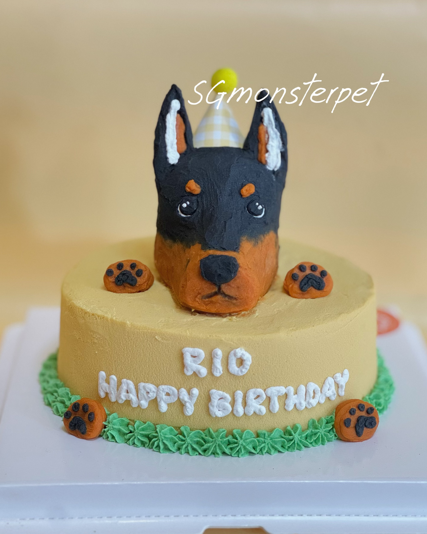 Dog-shaped birthday cake with Happy Birthday text on a plain background