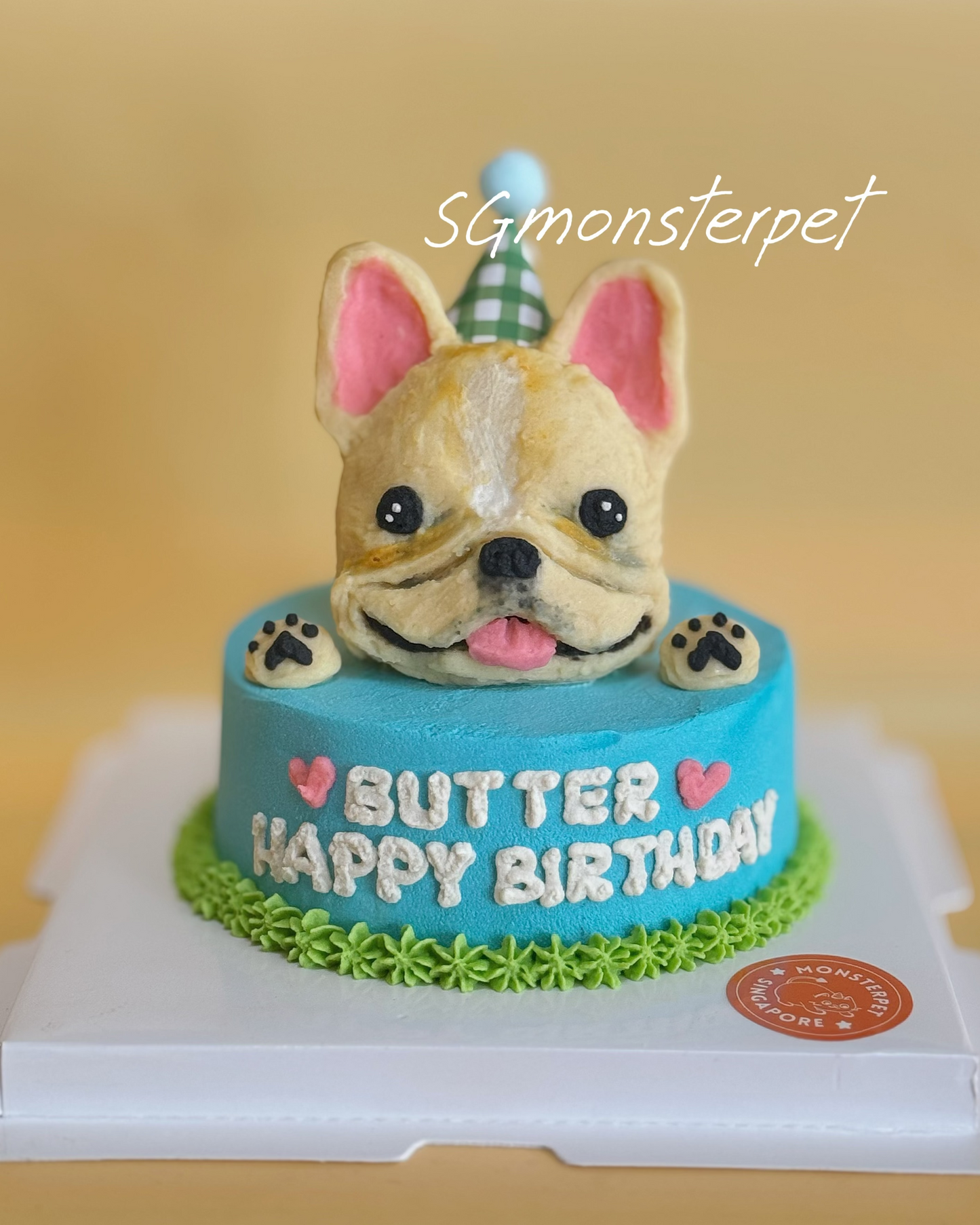 Birthday cake with a dog figurine on top, featuring the text 'Happy Birthday'.