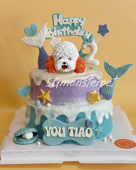 Two-tier birthday pet cake with mermaid-themed decorations