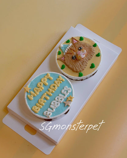Small round birthday cake with a cat design on a white plate against a yellow background.