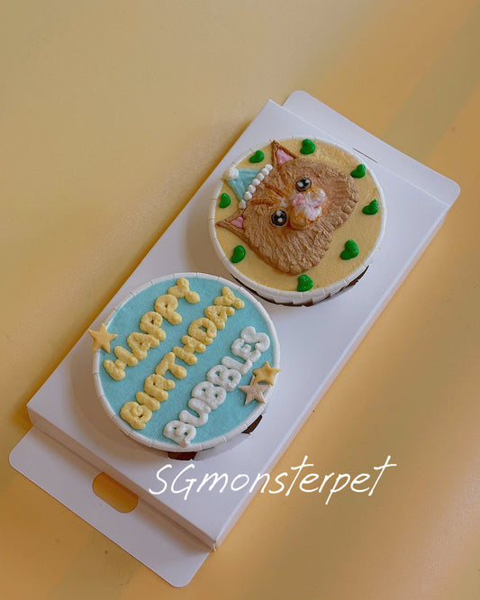 Small round birthday cake with a cat design on a white plate against a yellow background.