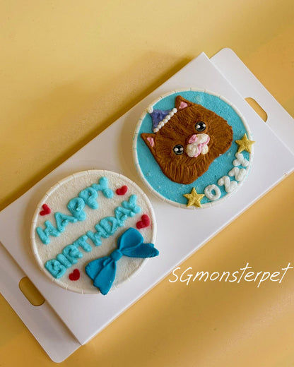 Two decorative cookies with a cat design and 'Happy Birthday' text on a yellow background.