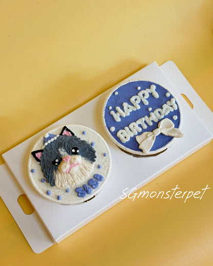 Two decorative cupcakes with a cat design and 'Happy Birthday' text on a yellow background.