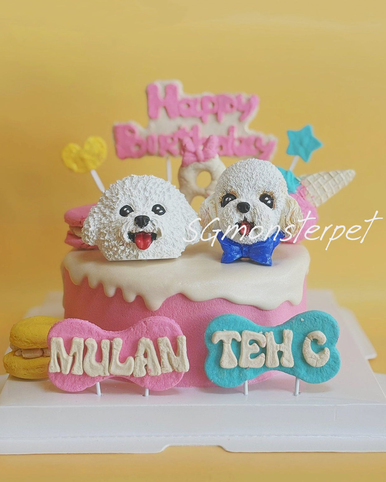 Birthday pet cake with dog figurines and personalized name on a yellow background
